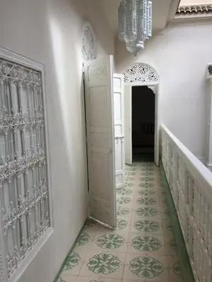 a hallway with a door and a tile floor at EDEN KAM Riad in Marrakech