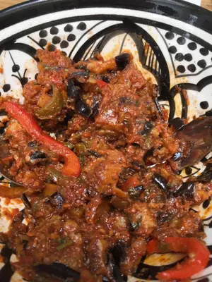 a plate of food with meat and vegetables at EDEN KAM Riad in Marrakech