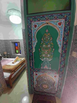 a christmas door with a christmas tree painted on it at Riad 112 in Marrakech