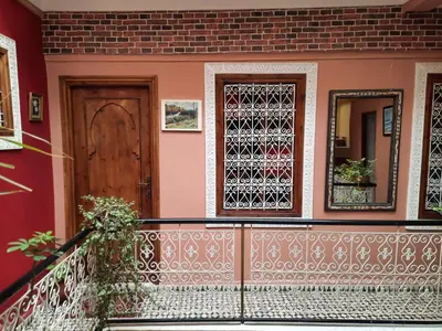 a house with a door and a balcony at Riad 112 in Marrakech