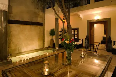 a living room with a vase of flowers on a table at Dar Rocmarra in Marrakech