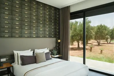 a bedroom with a large bed and a large window at Villa BELYA in Marrakech