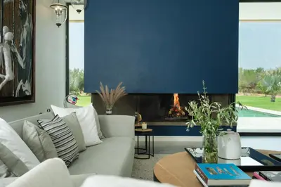 a living room with a white couch and a fireplace at Villa BELYA in Marrakech