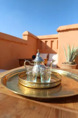 a tray with a tea pot and glasses on a table at Riad Azzouna 13 in Marrakech