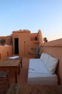 a patio with a couch and a table on a building at Riad Azzouna 13 in Marrakech