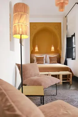 a bedroom with a large bed and a couch at Riad Dar Bahi in Marrakech