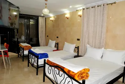 a room with two beds and a table at Silia in Marrakech