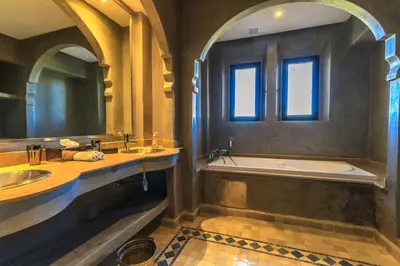 a bathroom with two sinks and a bath tub at Villa 69 Samanah Golf Country Club in Ala el Ma