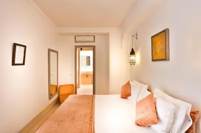 a bedroom with a white bed in a room at Hotel & Spa Riad Al Jazira in Marrakech