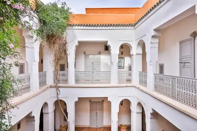 an external view of a white building with balconies at Hotel & Spa Riad Al Jazira in Marrakech
