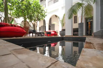 a pool of water in front of a building at Riad 64 Maison D'hôtes & Spa in Marrakech