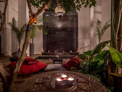 a living room with a table and some plants at Riad 64 Maison D'hôtes & Spa in Marrakech