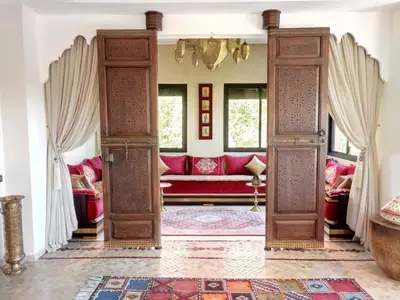 a living room with a red couch in a room at VILLA ILYANA in Marrakech