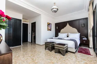 a bedroom with a large bed in a room at VILLA ILYANA in Marrakech