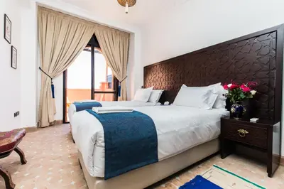 a bedroom with a large bed with a large headboard at VILLA ILYANA in Marrakech