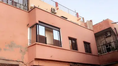 a pink building with windows on the side of it at Dar Soraya al Madina Marrakech in Marrakech