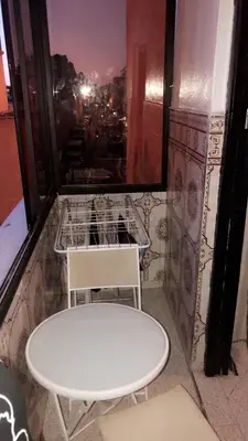 a table and two chairs in a room with a window at Dar Soraya al Madina Marrakech in Marrakech