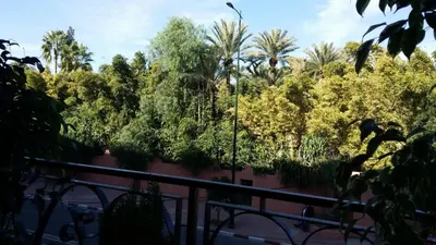 a view of trees from a balcony at Elegant Gueliz Retreat near Majorelle in Marrakech