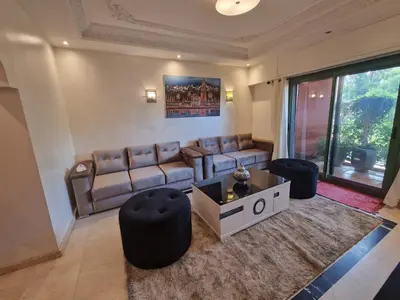 a living room with a couch and a table and chairs at Elegant Gueliz Retreat near Majorelle in Marrakech
