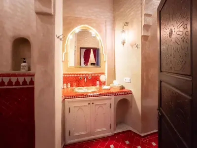 a bathroom with a sink and a mirror at Riad Selouane in Marrakech
