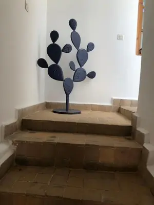 a metal sculpture sitting on top of some stairs at Dar Christine in Marrakech