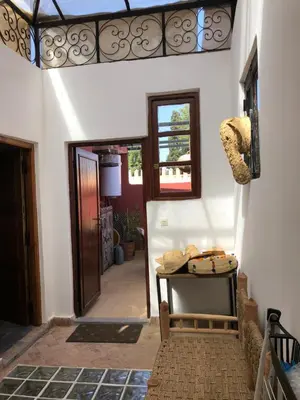 a hallway of a house with a door and a table at Dar Christine in Marrakech