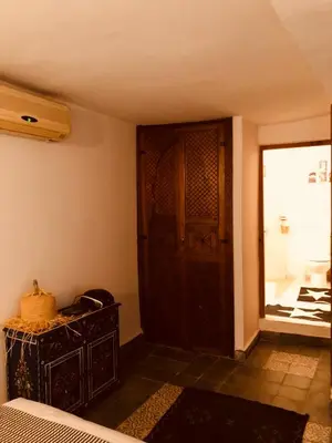 a room with a wooden cabinet and a door at Dar Christine in Marrakech