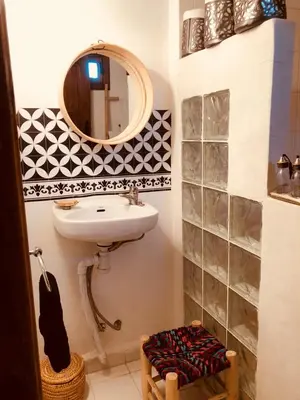 a bathroom with a sink and a mirror at Dar Christine in Marrakech