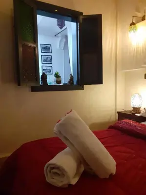 a roll of toilet paper sitting on top of a bed at Riad Simon in Marrakech