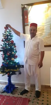 a man standing next to a christmas tree at Riad Simon in Marrakech