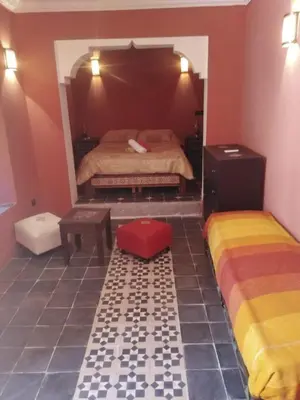 a bedroom with two beds in a room at Riad JEREMY in Marrakech
