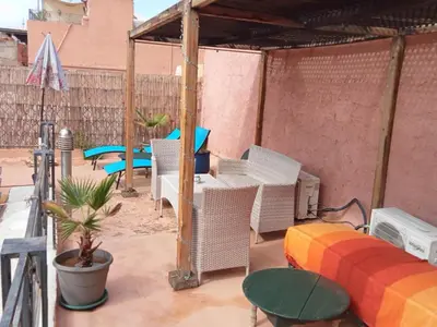 a patio with a couch and chairs and a table at Riad JEREMY in Marrakech