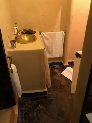a bathroom with a sink and a towel at RIAD DES DEUX MERS in Marrakech