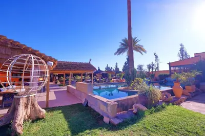 a backyard with a swimming pool and a house at Hacienda Marrakech in Marrakech
