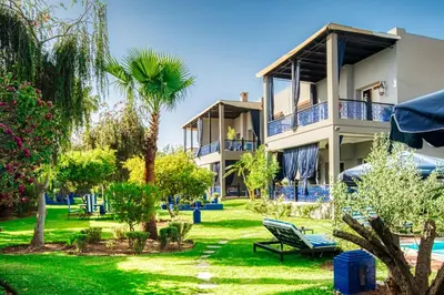 a resort with a yard with chairs and trees at Villas 95 Appart'Hôtel in Marrakech