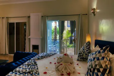 a bedroom with a bed with a bedspread on it at Villas 95 Appart'Hôtel in Marrakech