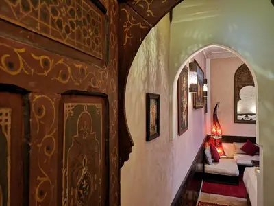 a hallway of a house with an archway and a living room at Riad Charme d'Orient Adults Only in Marrakech