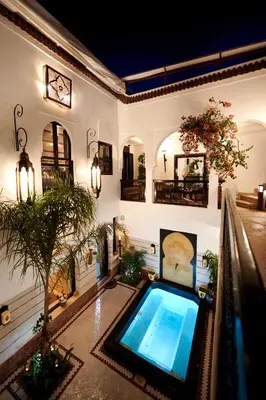 a house with a swimming pool in the middle of it at Riad Dar Amanza en exclusivité avec 4 chambres au coeur de la médina in Marrakech