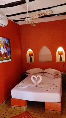 a bedroom with a bed with a heart decoration on it at Riad Laith in Marrakech