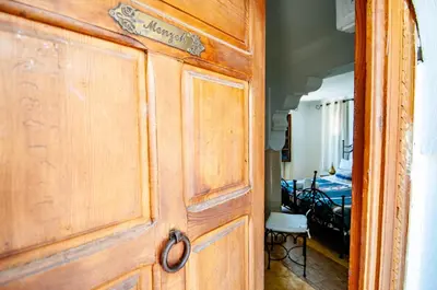 a wooden door in a room with a bedroom at Hotel & Spa Riad Dar El Aila in Marrakech