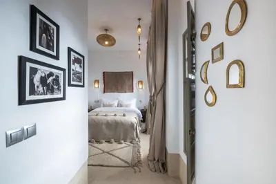 a bedroom with a bed and some pictures on the walls at Riad Louhou in Marrakech