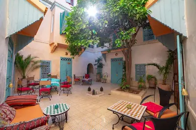 a patio with tables and chairs in a courtyard at Riad Dar Marhaba in Marrakech