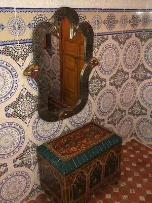 a mirror with two swans on a wall at Dar HAJAR in Marrakech