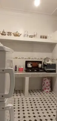 a bathroom with a shelf with pots and pans at Dar HAJAR in Marrakech