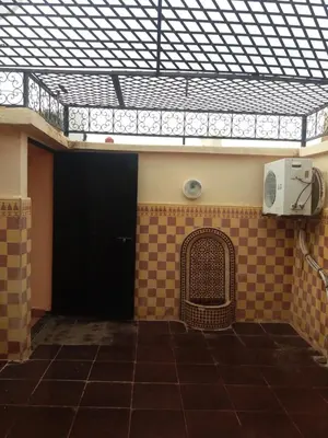 a building with a black door and a tile floor at Riad Safae in Marrakech