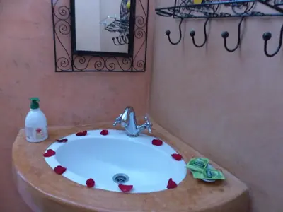 a bathroom with a sink with hearts on it at Riad Jakoura in Marrakech