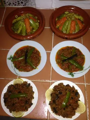 four plates of food on a table with food at Riad Jakoura in Marrakech