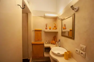 a small bathroom with a toilet and a mirror at Riad Boussa in Marrakech