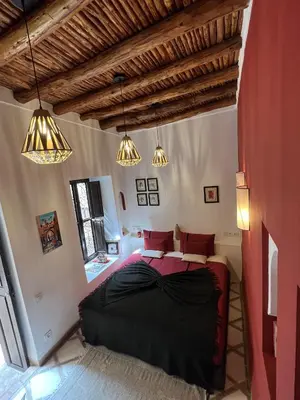 a bedroom with a large bed in a room at Riad Boussa in Marrakech