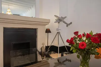 a room with a fireplace with a vase of roses at Riad & Spa Azzouz in Marrakech